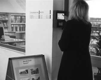 dealings with the library (borrower status, reservation, bills). A chip-reader reads the material when placed on a shelf by the info stand.
