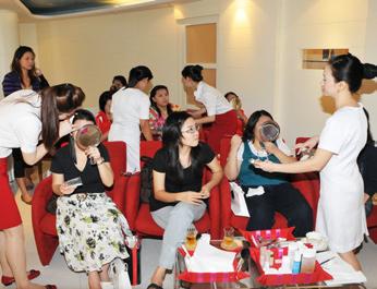 Beauty starts with a good complexion Participants at a Basic Skincare and Make-up Workshop pick up useful tips and Clarins products.