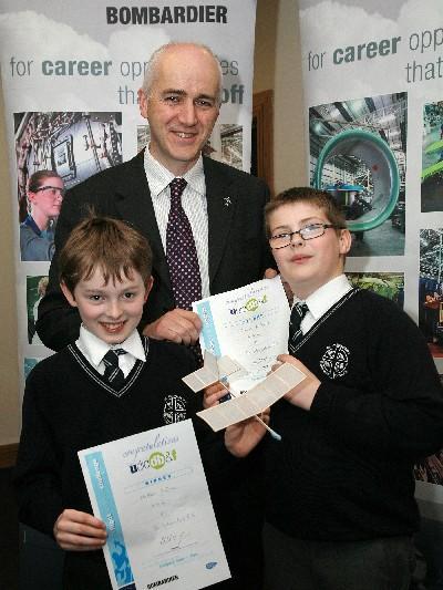 Matthew & Conor receiving their prize from Bombardier. Mr McKenna receives the 1000 cheque from Bombardier education officer Tony Monaghan.