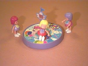 The first girl gets on the merry-go-round and starts riding, Picture 5.