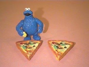 Picture 3: Cookie Monster barely finishes the second slice After these two huge slices of pizza, Cookie Monster is really full.