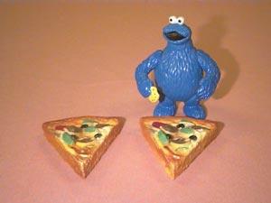 Next, Cookie Monster considers the fourth slice but once again, he realizes that he is too full to eat it, Picture 5.