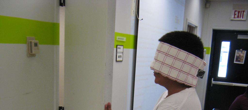 Image 2. Student blind folded with cane, building empathy for the visually impaired 3.