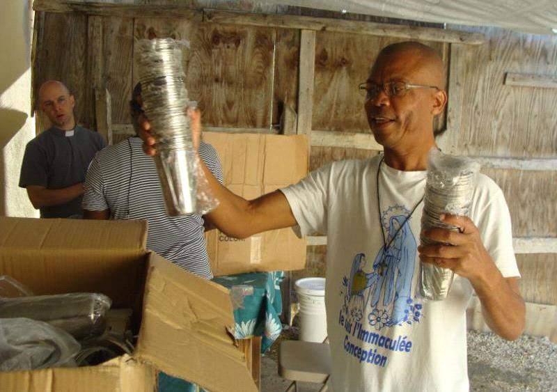 (Below) Pe Josue holds up the new drinkware provided for the
