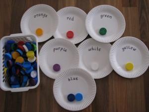 SORTING COLOURS WITH BOTTLE TOPS Sorting colours with bottle tops encourages children to place and sort coloured bottle tops onto the matching colour paper plate.