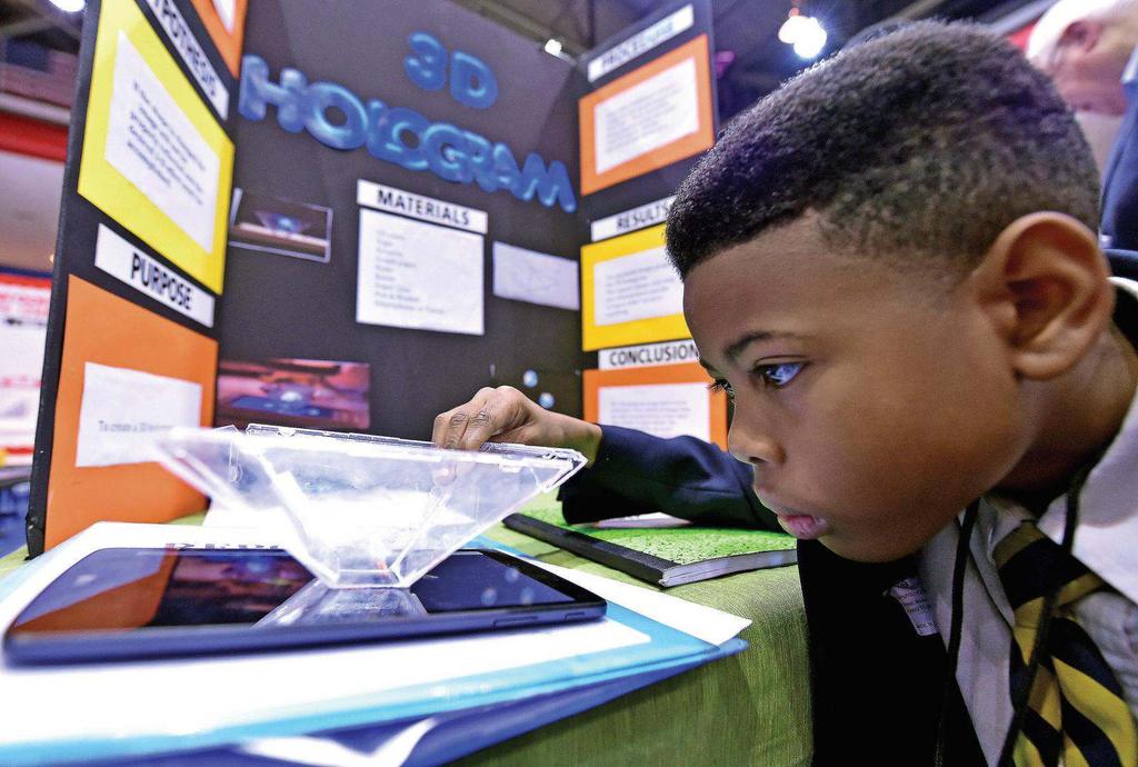 JUSTIN SELLERS/ Fourth-grader Christopher Fulgham, 10, tests his 3D hologram project during the 2016 Mississippi Region II Science and Engineering Fair at Jackson State University.