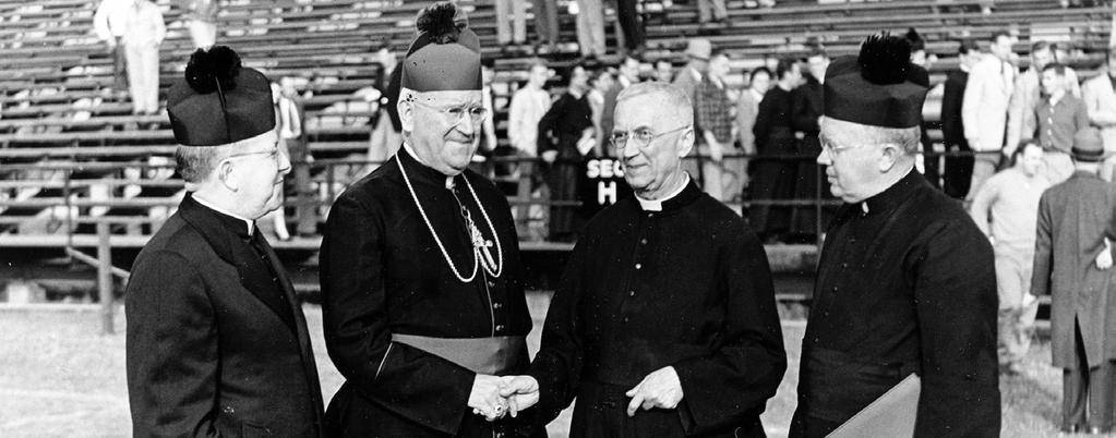 Rev. Eugene Alliot, SSE, former president of Saint Michael s College, shakes hands with Bishop Edward Ryan while Superior General of the Society of Saint Edmund Rev.