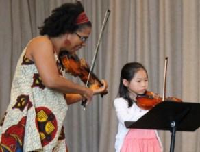 BAC Teaching Artist accompanies a third grade beginning violinist.