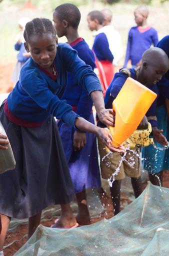 A student makes a splash at Loibor Siret Primary School as she waters the wildlife club s