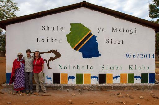 BCI Grantee Laly Lichtenfeld (right) stands in front of the newly painted Loibor Siret Primary School with