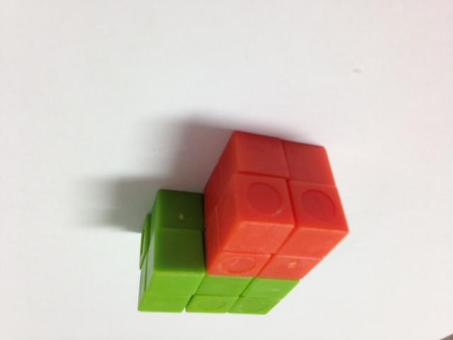 à The volume is 20 cubic units. T: Now, build a different structure using the two prisms, and find the volume. S: (Work.