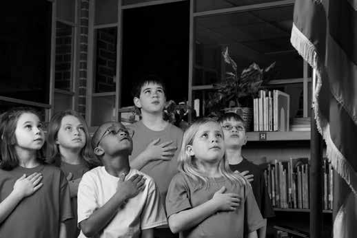 A teacher leads her class in saying the Pledge of Allegiance long ago. 1.