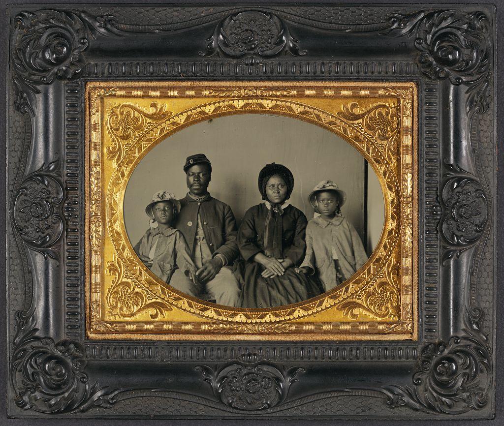 Title: Unidentified African American soldier in Union uniform with wife and two daughters Author/Creator: [unknown] Date: [between 1863 and 1865] Summary: Photograph showing soldier in uniform, wife