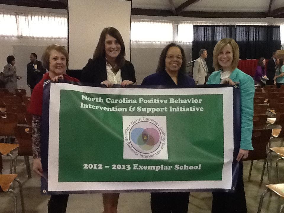 Huntsville Elementary- Exemplar Banner Pictured: (L to R) Polly Yeago, Teacher, Amanda Yates, Teacher; Dr.