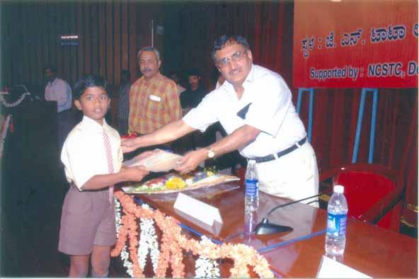 Student receiving the prize from Prof. M. K.