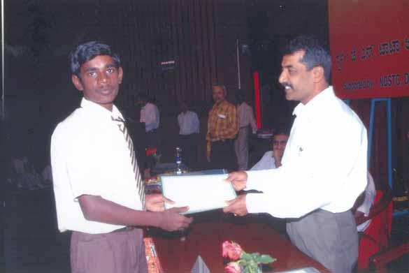Student receiving the prize from Mr. A. R.