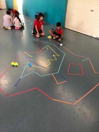 For the mini golf challenge, the students designed their own mini golf course using tape and then collaboratively programmed their robot to move through the course without touching the edges.