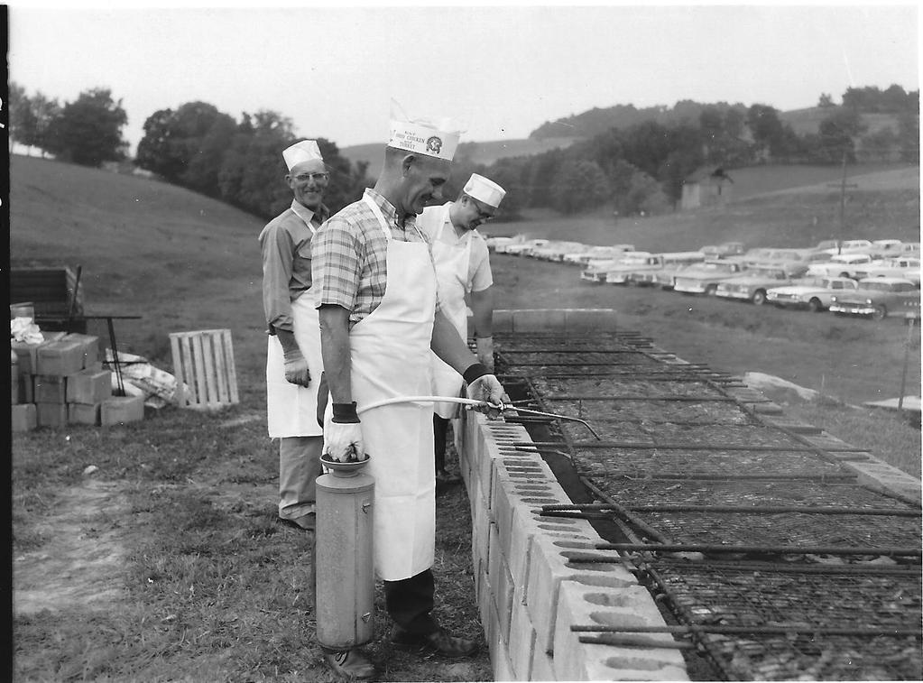 (Harrison SWCD), Harry Smith (Vo-Ag), and Robert Lahmers (4-H Agent) barbecuing some of the 325 halves of chicken at a Pasture Field Day in Cadiz on October 30th, 1967.