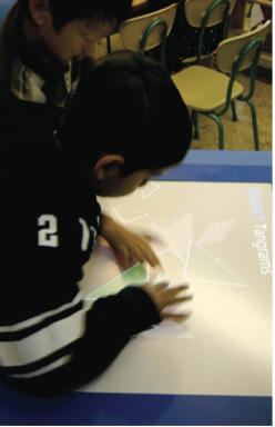 6 figure 4. A child uses a traditional interface to solve a tangram puzzle task. The user used the mouse to rotate the shape and drag it to the right location.