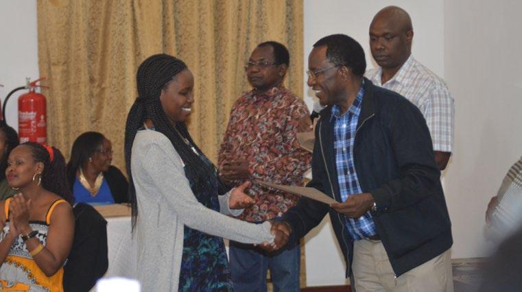 3 Best Performing Student Honoured The Vice Chancellor, Prof Timothy Wachira congratulates one of the awardees, assisted by the Dean School of Business & Economics, Mr.