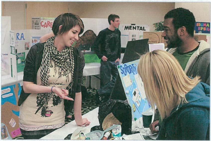 EMU HOME April 14, 2009 issue WRITING CELEBRATION: (above, from left) Kate McKenna discusses her writing project to EMU students Jelani McGadney and Stephani Houghton during the annual Celebration of