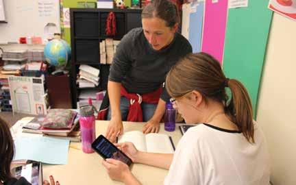 Liberty Middle School teacher helps students learn with tablets.