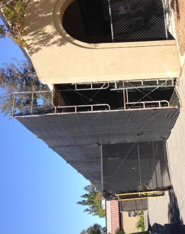 the parapets, and installing new weatherproof coatings on the exterior surfaces.