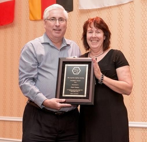 Pam Kniess received the President's Achievement Award from International System Safety Society President Bob Schmedake.