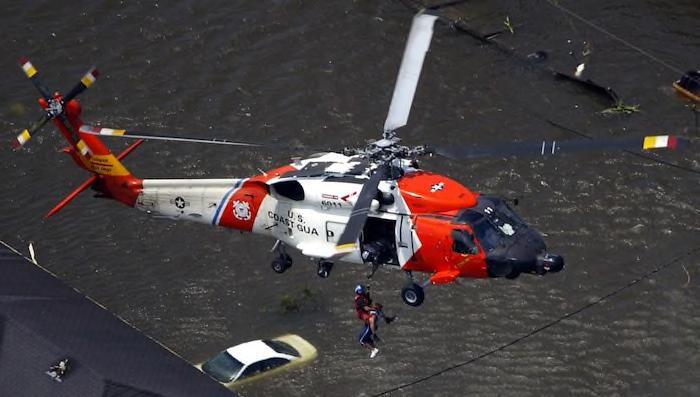 A resident is rescued by the U.S. Coast Guard from the roof top of a home in New Orleans on Aug. 30, 2005. (AP Photo/David J.