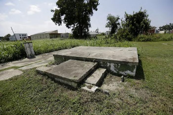 A foundation of a former structure is seen with new construction in the background in the Lower 9th Ward in New Orleans.