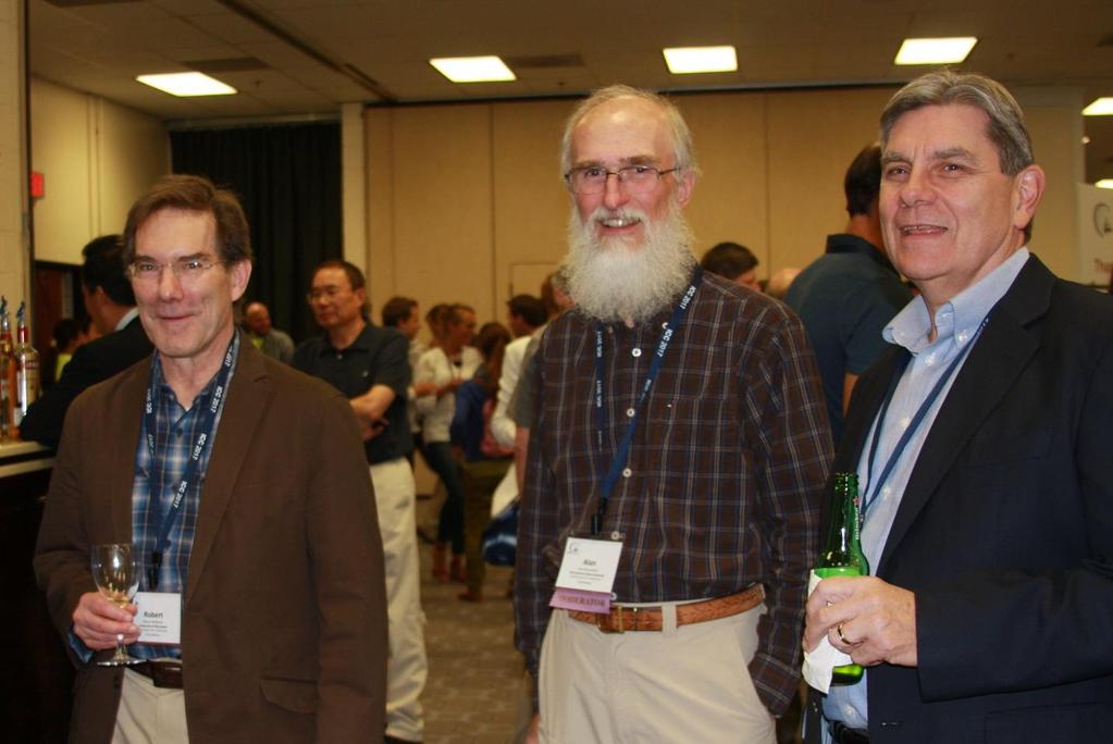 (From left to right) Bob McMaster, Alan MacEachren, and Tim Nyerges catch up at the icebreaker reception on July 3. (Photo by Dierdre Bevington-Attardi.