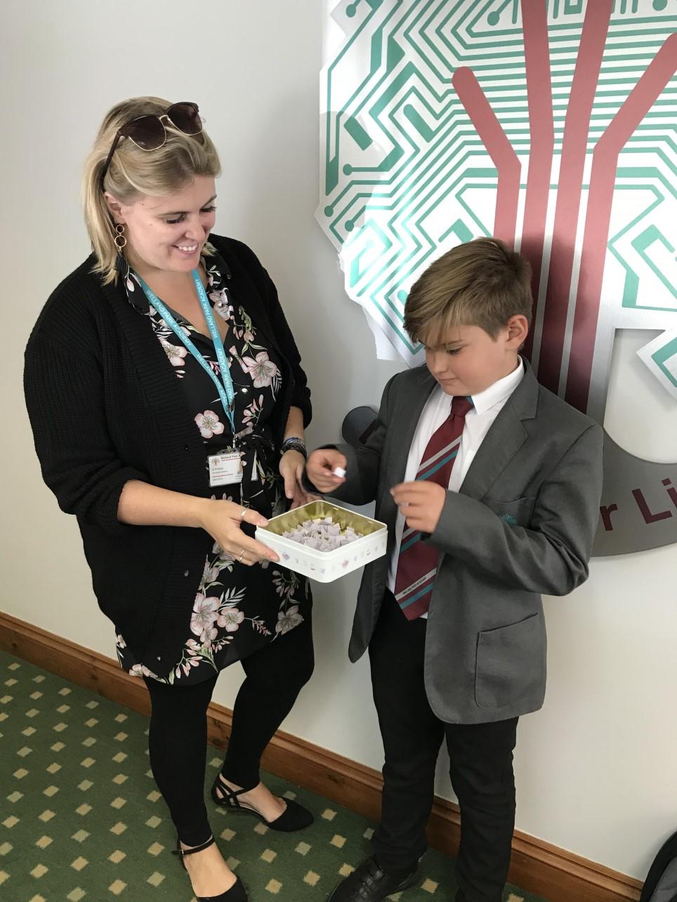 MACMILLAN COFFEE MORNING Sam Price (Year 7) and Miss Pithers drawing the raffle for