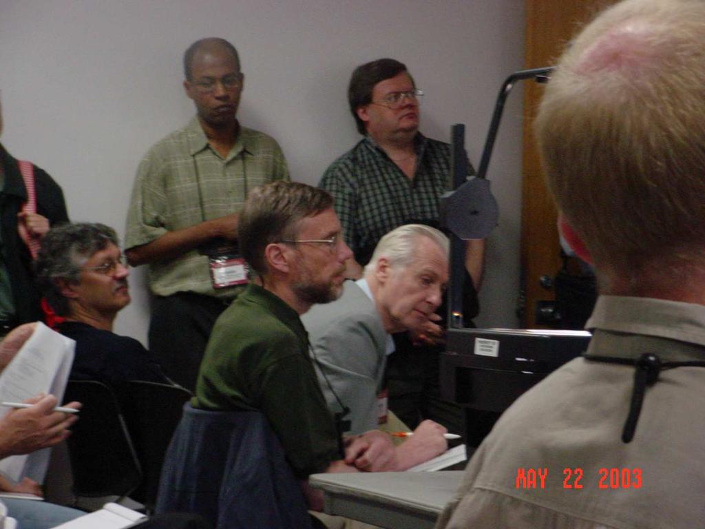 Figure 3: Wayne Nelson (silver-haired) and Odd Aalen (beside the projector) sitting beside each other while