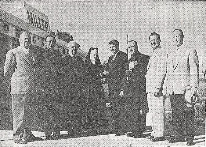 J. Douglas Miller, the builder and general contractor charged with erecting the first section of St. Hedwig Catholic School, hands over the keys to Sister Mary Rachel, the first principal. L to R: Mr.