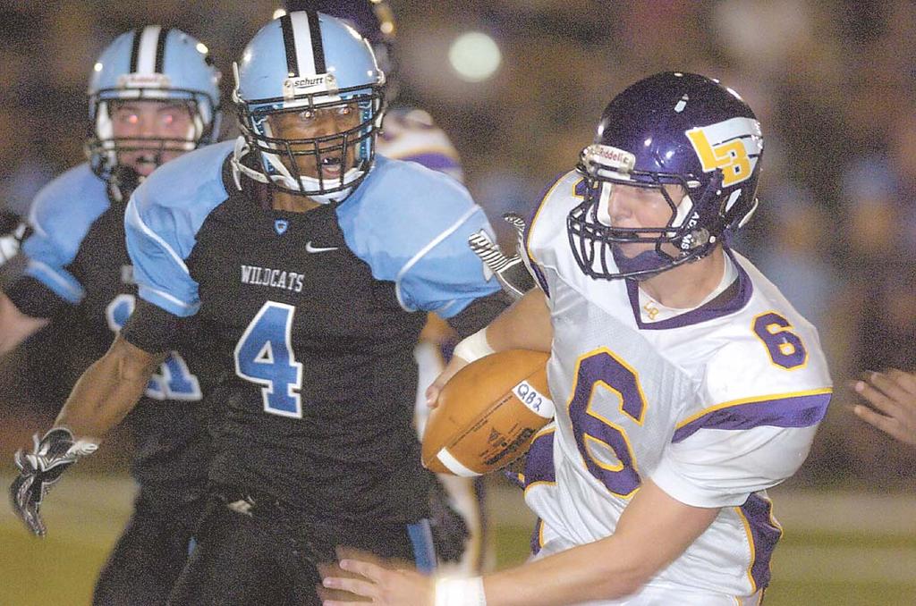 Photos by Craig Sterbutzel/Centre View Sports Centreville s Xavier Nickens-Yzer (4) chases after Lake Braddock quarterback Caleb Henderson. Centreville running back Taylor Boose scores a touchdown.